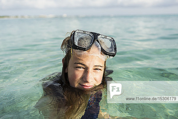 A teenage girl wearing snorkelling mask in the ocean