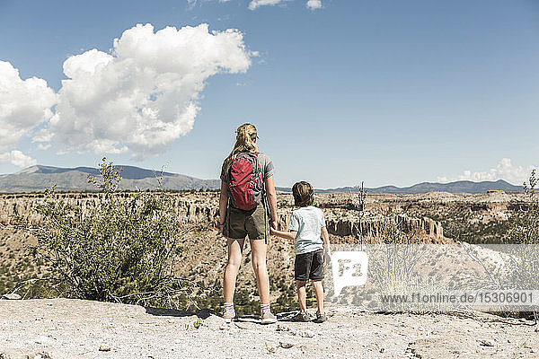 Brother and sister holding hands visiting a prehistoric site in New Mexico