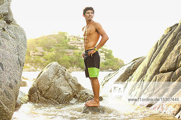 Young  fit man standing on ocean rock  Sayulita  Nayarit  Mexico