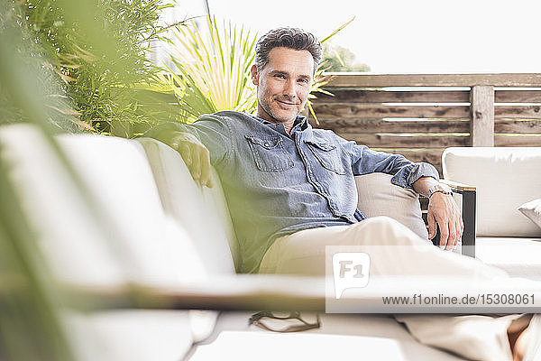 Confident man relaxing on the terrace