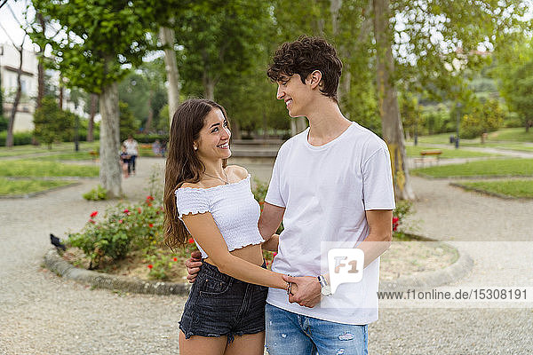 Young couple holding hands in a park