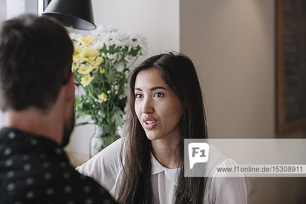 Young couple talking in a cafe