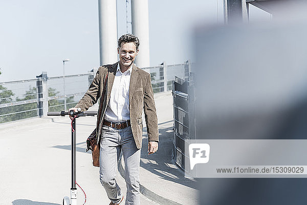 Businessman with E-Scooter