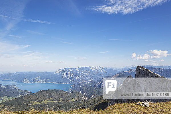 Scenic view of Spinnerin and Attersee against blue sky