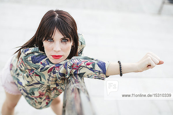 Portrait of young woman posing wearing patterned blouse