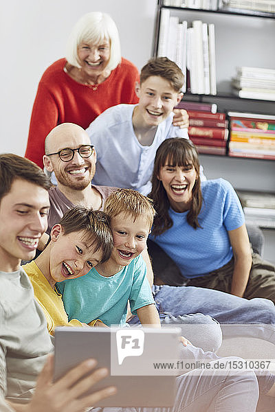 Big familiy having fun at home  using digital tablet