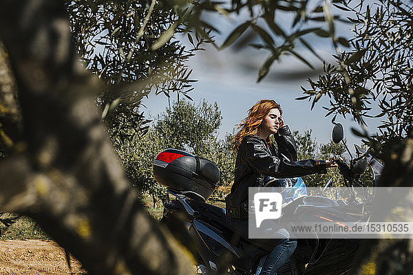 Redheaded woman on motorbike  Andalusia  Spain