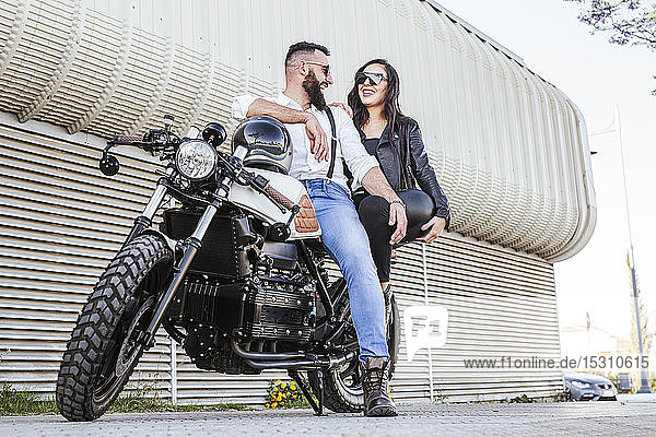 Laughing couple on motorbike