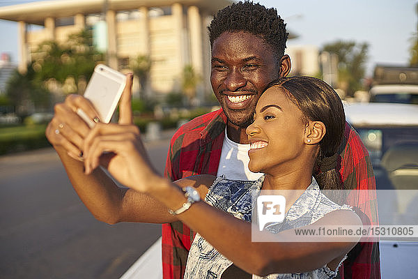 Young couple taking samrtphone selfies  Mabuto  Mozambique
