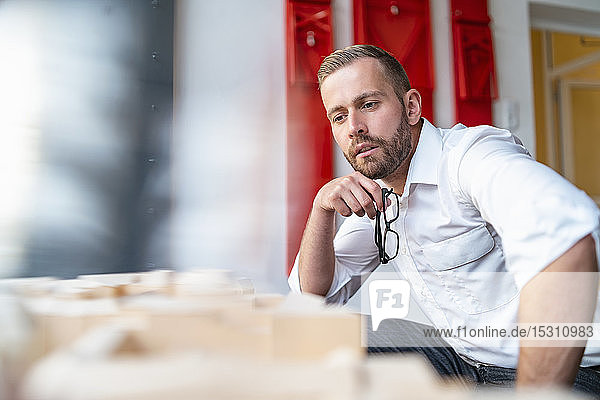 Businessman looking at architectural model in office