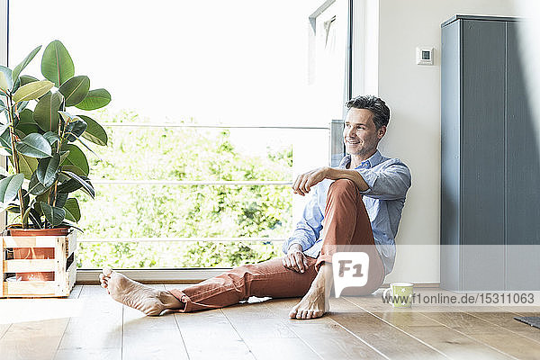 Mature man relaxing at home with a cup of coffee