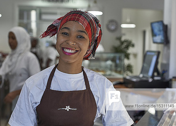 Young woman working in ice cream parlour  portrait