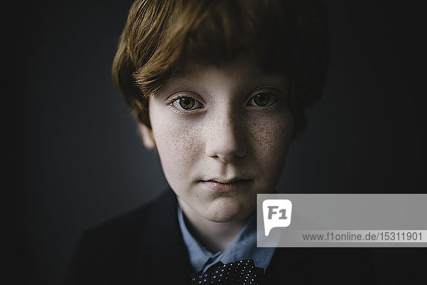 Portrait of sad boy with freckles