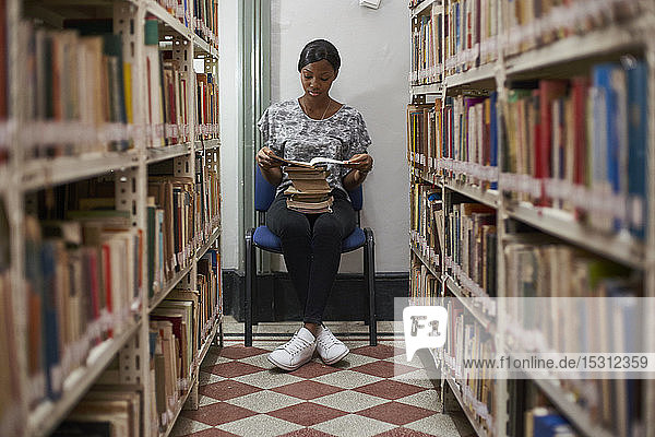 Young woman reading a book at National library  Maputo  Mocambique