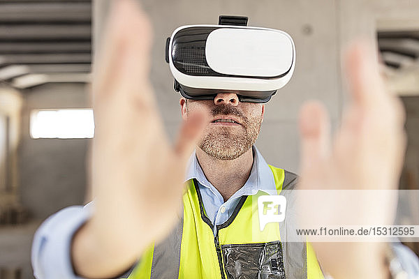 Architect with VR glasses at construction site