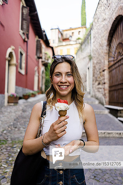Portrait of happy young woman with ice cream cone