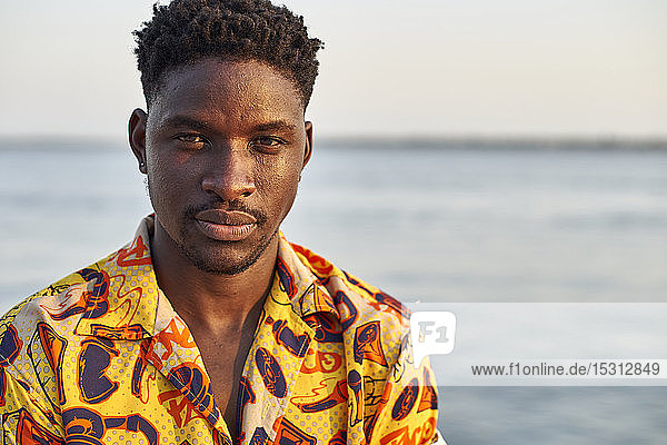 Young man standing at the sea  portrait