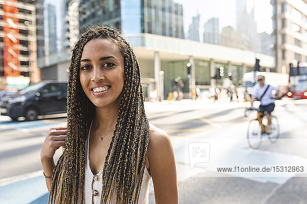 Portrait of smiling young woman in the city  London  UK