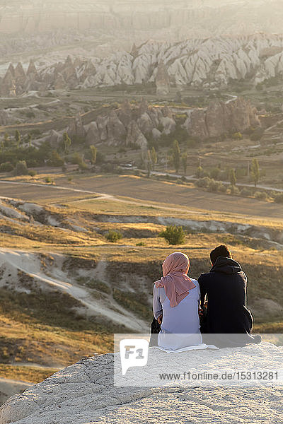 Couple enjoying the view of rocky landscape at dusk  Goreme  Cappadocia  Turke
