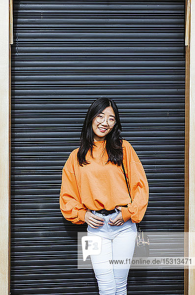 Asian woman in front of black wall