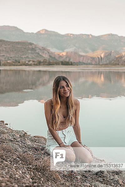 Young blond woman at a lake