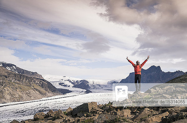 Mature man standing in Skaftafell National Park  looking at Vatnajokull glacier  Iceland