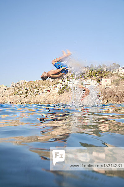 Friends jumping into the sea  Mallorca  Spain