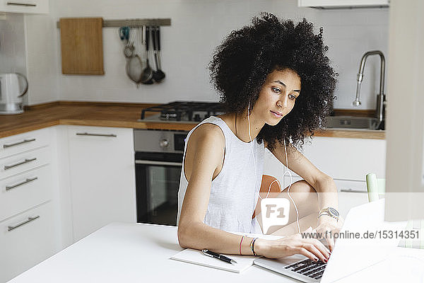 Young woman doing an online course on laptop