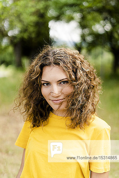 Portrait of smiling young woman in a park