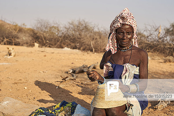 Mucubal tribe woman sewing a traditional pot  Tchitundo Hulo  Angola.