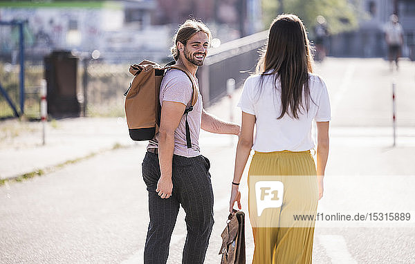 Happy young couple walking on the street