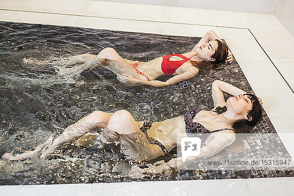 Two women enjoying the whirlpool in a spa