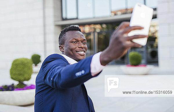 Young businessman taking a selfie