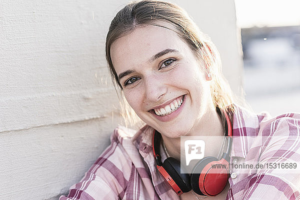 Portrait of smiling young woman with headphones