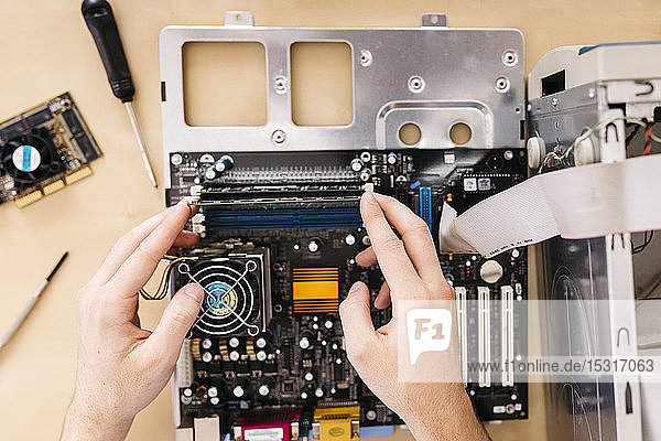 Close-up of technician repairing a desktop computer  changing the computer's RAM