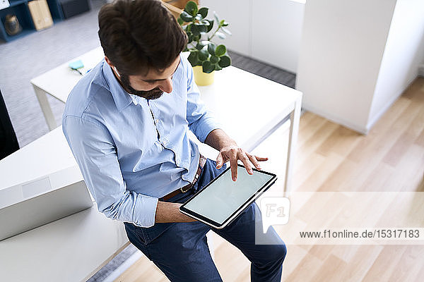 Businessman using a digital tablet in his office