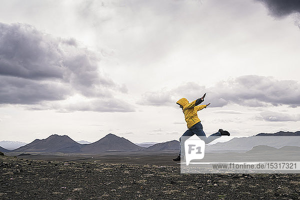 Mature man jumping for joy in the Highland Region  Iceland