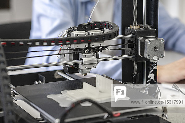 Student setting up 3D printer  close up