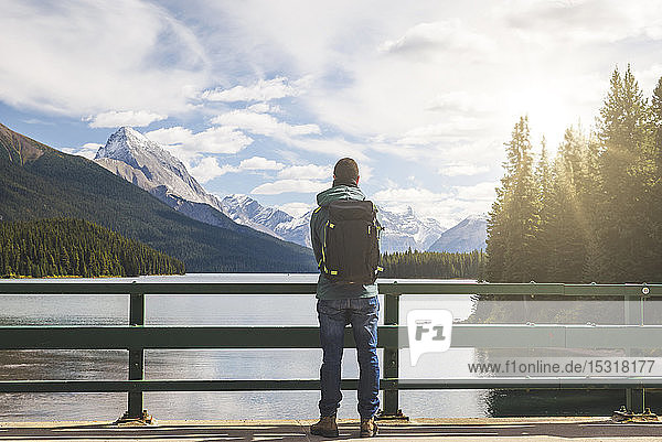 Tourist with backpack enjoying the view over Maligne Lake  Canada