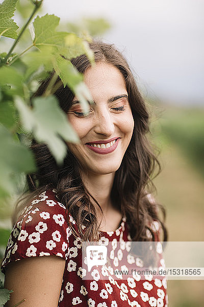 Portrait of laughing young woman in the vineyards