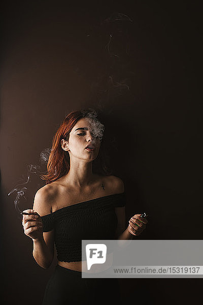 Junge Frau raucht zu Hause Marihuana