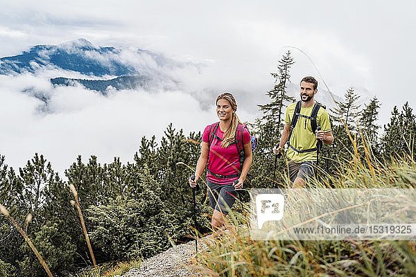 Confident young couple on a hiking trip in the mountains  Herzogstand  Bavaria  Germany