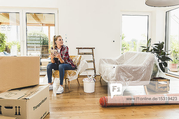Woman moving into new home using tablet