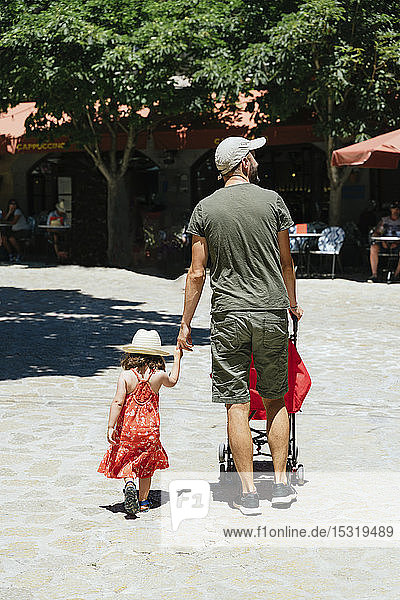 Back view of little girl walking hand in hand with her father  Valldemossa  Mallorca  Spain