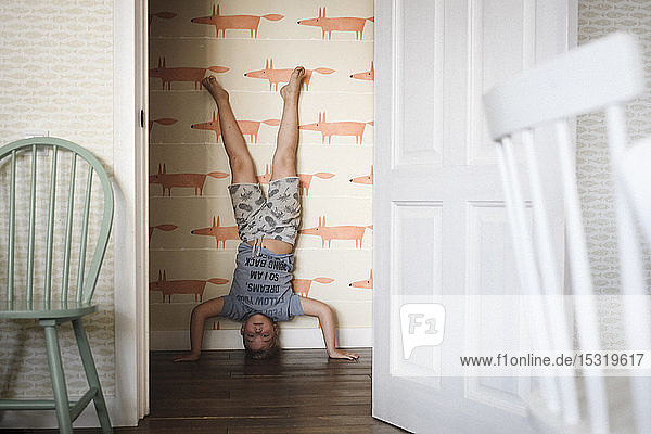 Boy doing a headstand at home