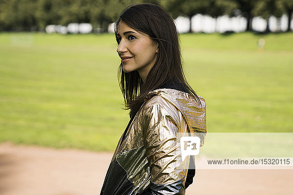 Portrait of young woman wearing shiny jacket