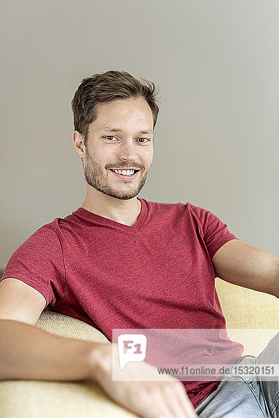 Portrait of a smiling man sitting on a couch