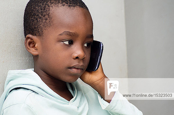 Child listening with great attention that his mother told him on the phone.