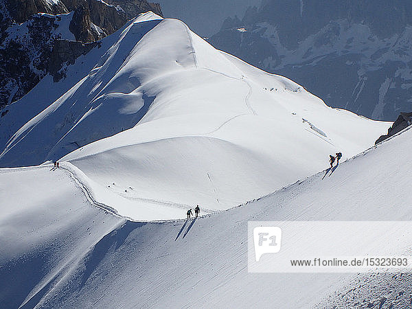 France  haute savoy  Chamonix  Mont blanc range  some alpinists are hiking on the snow edge of the aiguille du midi
