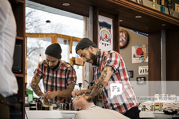 Barber washing man´s hair